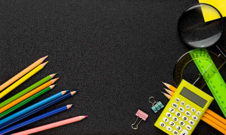 Many different school supplies on blackboard copy space background. Back to school concept.の写真素材