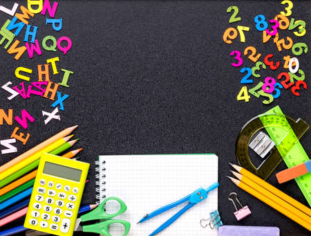 Many different school supplies on blackboard copy space background. Back to school concept.の写真素材