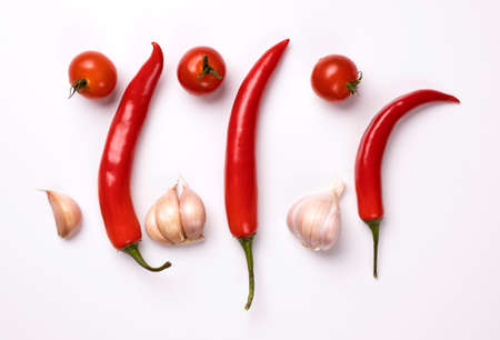 Red chili peppers, garlic and tomatoes isolated on white background.の写真素材