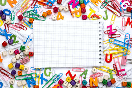 Flat lay of white notepad sheet of paper on office supplies background.の写真素材