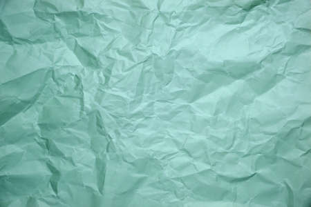 Close up of green crumpled empty sheet of paper.の写真素材