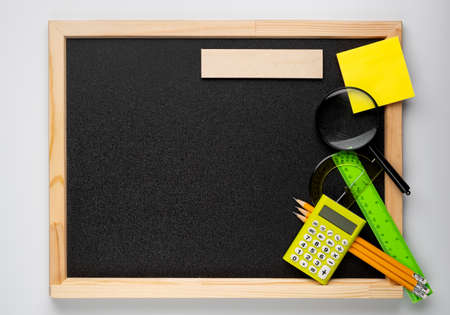 Many different school supplies on blackboard copy space background. Back to school concept.の写真素材