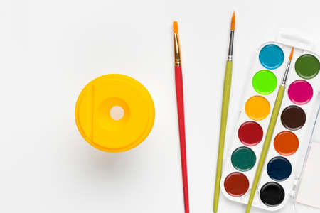 Top view of colorful watercolor paints set and brushes isolated on white backround.の写真素材