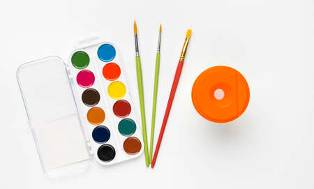 Top view of colorful watercolor paints set and brushes isolated on white backround.の写真素材