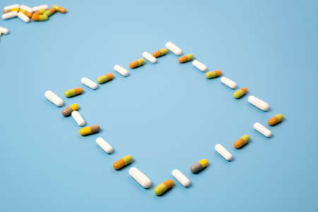 Close up of many different pills on blue background.の写真素材