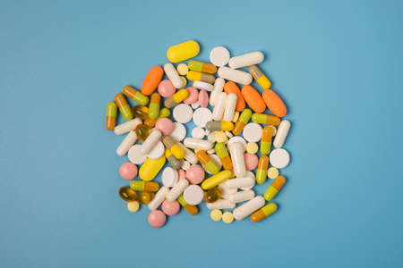 Close up of many different pills on blue background.の写真素材