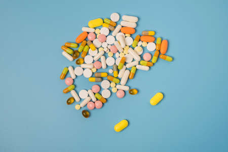 Close up of many different pills on blue background.の写真素材