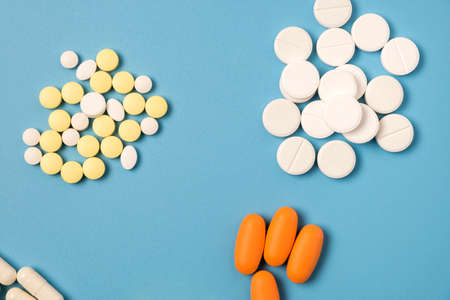 Close up of many different pills on blue background.の写真素材