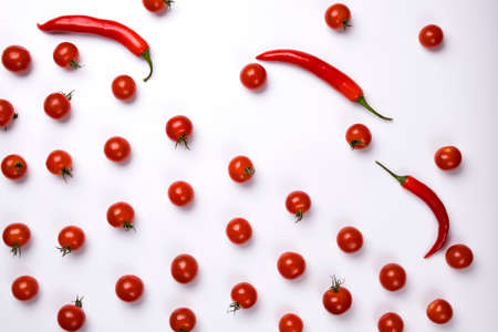 Red chili peppers and tomatoes isolated on white background.の写真素材