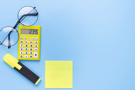 Many different school supplies on blue copy space background. Back to school concept.の写真素材