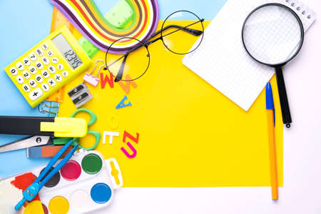 Many different school supplies on yellow copy space background. Back to school concept.の写真素材