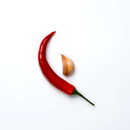 Red chili peppers and garlic isolated on white background.の写真素材