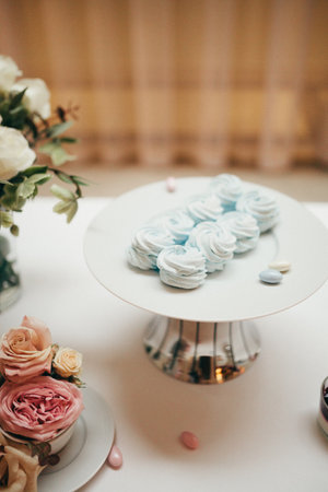 Pastel white and blue wedding cakes, dessert table for a wedding party. Wedding cookies decorated on a standの写真素材