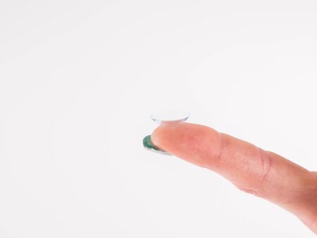 The contact lens on the finge