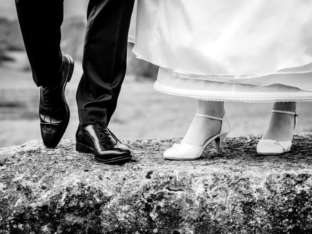 Bride and groom show their shoesの写真素材