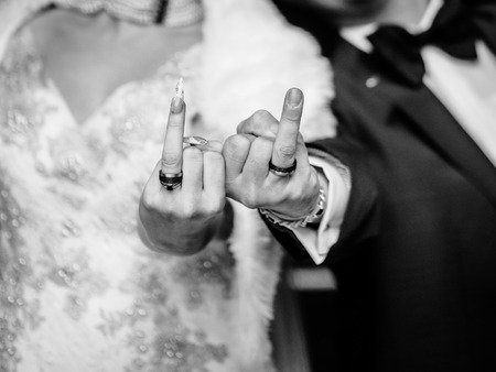 Cool bridal couple shows the ringsの写真素材