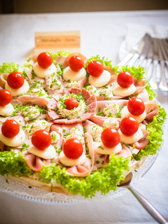 a hearty cake with sausage, cheese, salad and tomatoesの写真素材