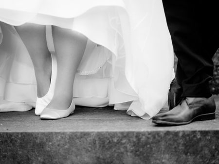 The bride and groom shows the shoes at the weddingの写真素材