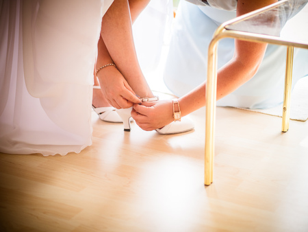 A close up image of elegant floor-length wedding dress. Concept of bride morning.の写真素材