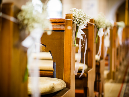 Beautiful decor of white flowers in church for a wedding ceremony in colorの写真素材
