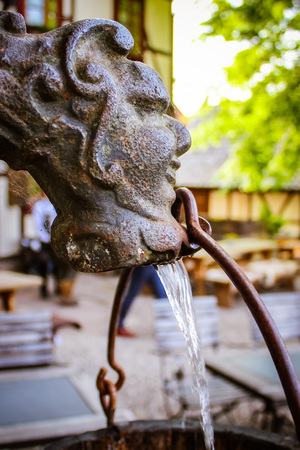 The vintage water pump on the castle, middle ages historicの写真素材