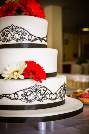 The wedding cake with red gerbera and beautiful decorationの写真素材