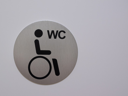 The disability sign, sign with space to write, a photographed sign behind wheelchair accessibleの写真素材