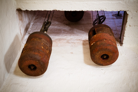 the weights in the tower clock, church,tower, clock mechanism, clockwork photographed from the inside and just rearedの写真素材