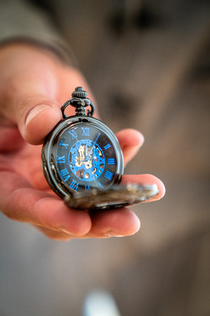 The pocket watch in noble blue, is held in the handの写真素材