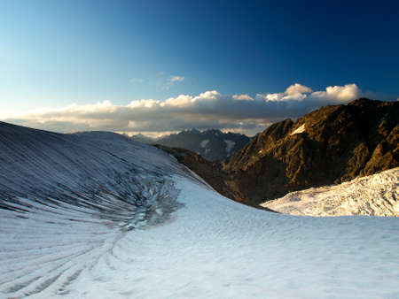 High rock and glacier during sundown