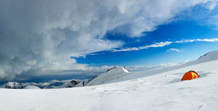 Panorama of the snowy mountains and tourist campの写真素材