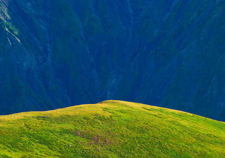 Hill on the background of dark mountainの写真素材