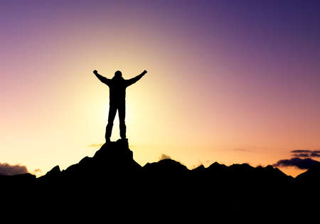 Silhouette of a winner on the mountain top