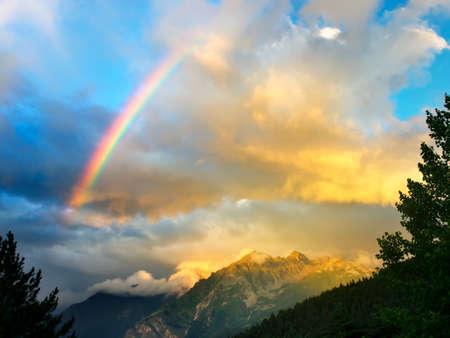 Rainbow in the mountain valley after rainの写真素材