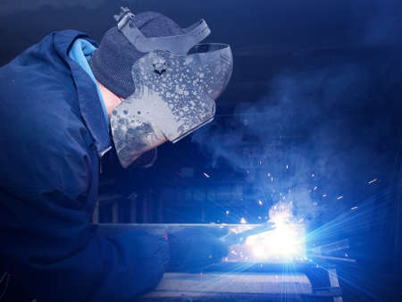 Welder on industrial workplace