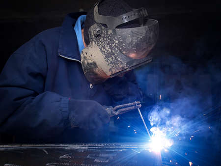 Welder on the industrial workplace