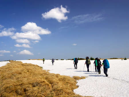 Tourist team on snow plain の写真素材