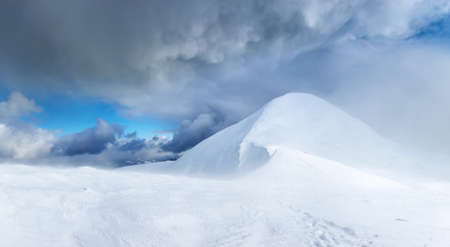 Snowy top during storm. Beautiful winter landscapeの写真素材
