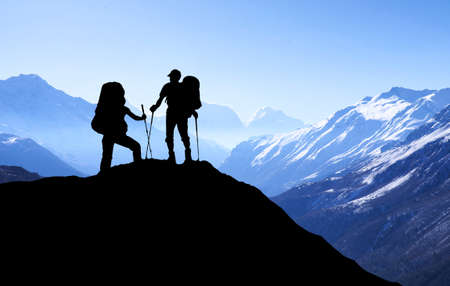 Silhouette of tourists in mountains. Sport and active life conceptの写真素材