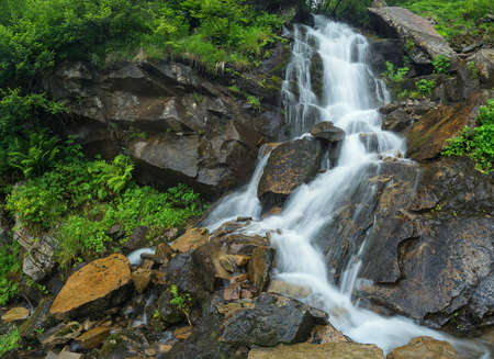Waterfall in summer canyon. Beautiful natural landscape