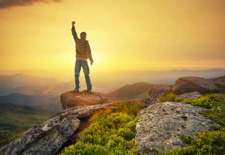 Silhouette of a champion on mountain peak. Active life conceptの写真素材
