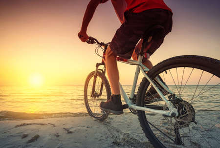 Ride on bike on the beach. Sport and active life conceptの写真素材