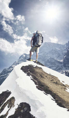 Tourist on mountain peak. Sport and active life conceptの写真素材