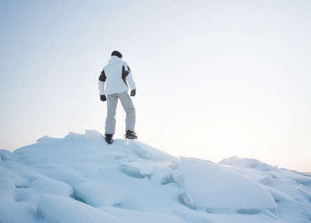 Silhouette of a tourist on the peak of high rocks. Sport and active life conceptの写真素材