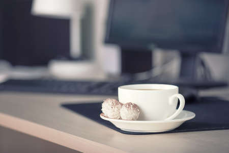 Cup with coffee on the workplace. Bussines concept and ideaの写真素材