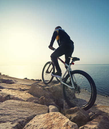 Ride on bike on the beach. Sport and active life conceptの写真素材