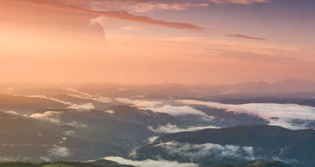 Mountain panorama during sundown. Beautiful natural panoramic landscape in the summer timeの写真素材