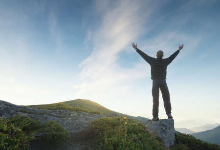 Silhouette of a winner on mountain top. Sport and active life concept
の写真素材