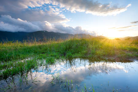 Lake and reflection at the water surface. Natural landscape at the morning timeの写真素材