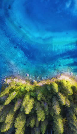 Aerial view on the lake and forest. Natural landscape from drone. Aerial landscape from air in the Dolomite alps, Italy.の写真素材